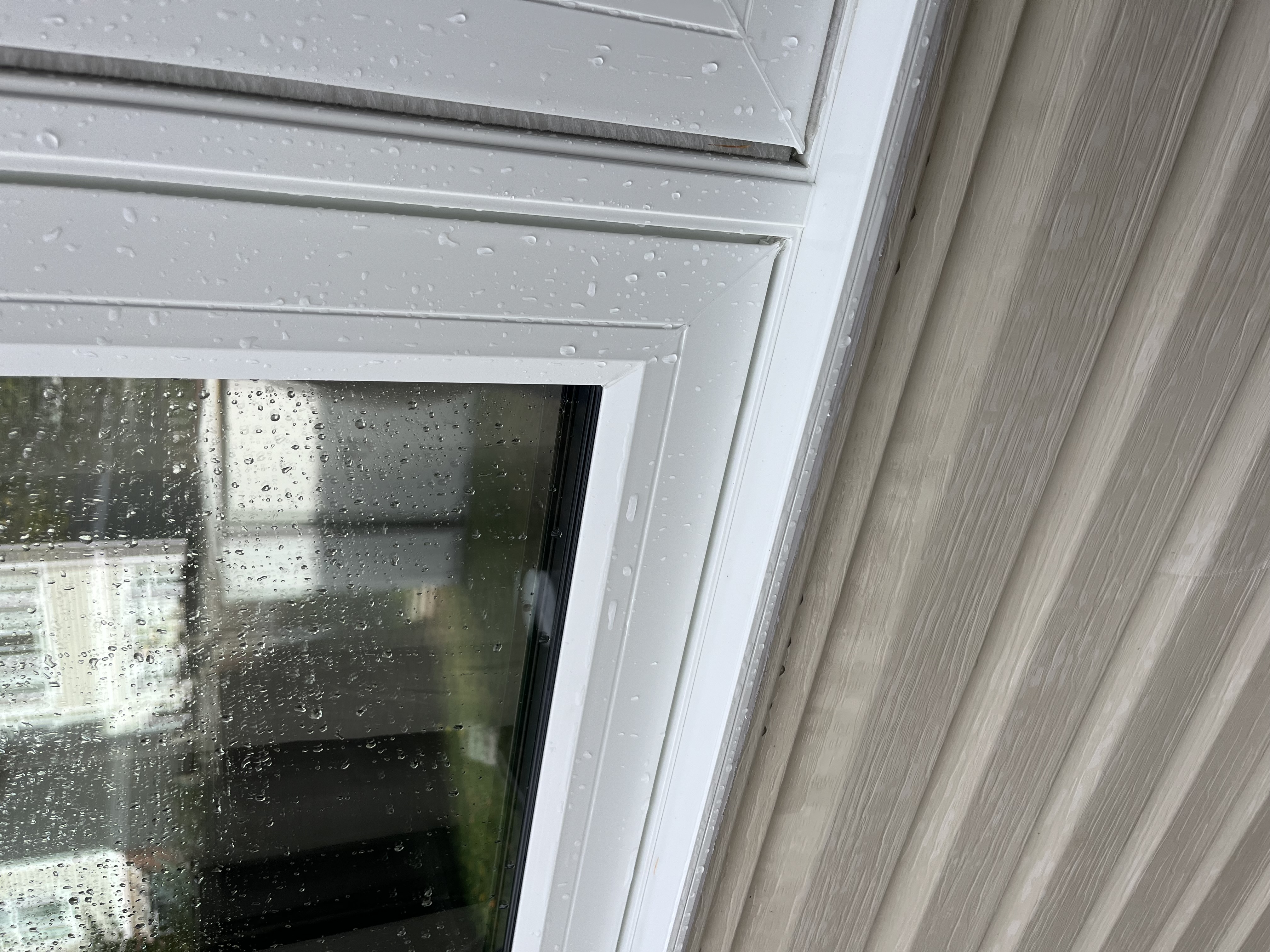 Clean siding and window with rain droplets