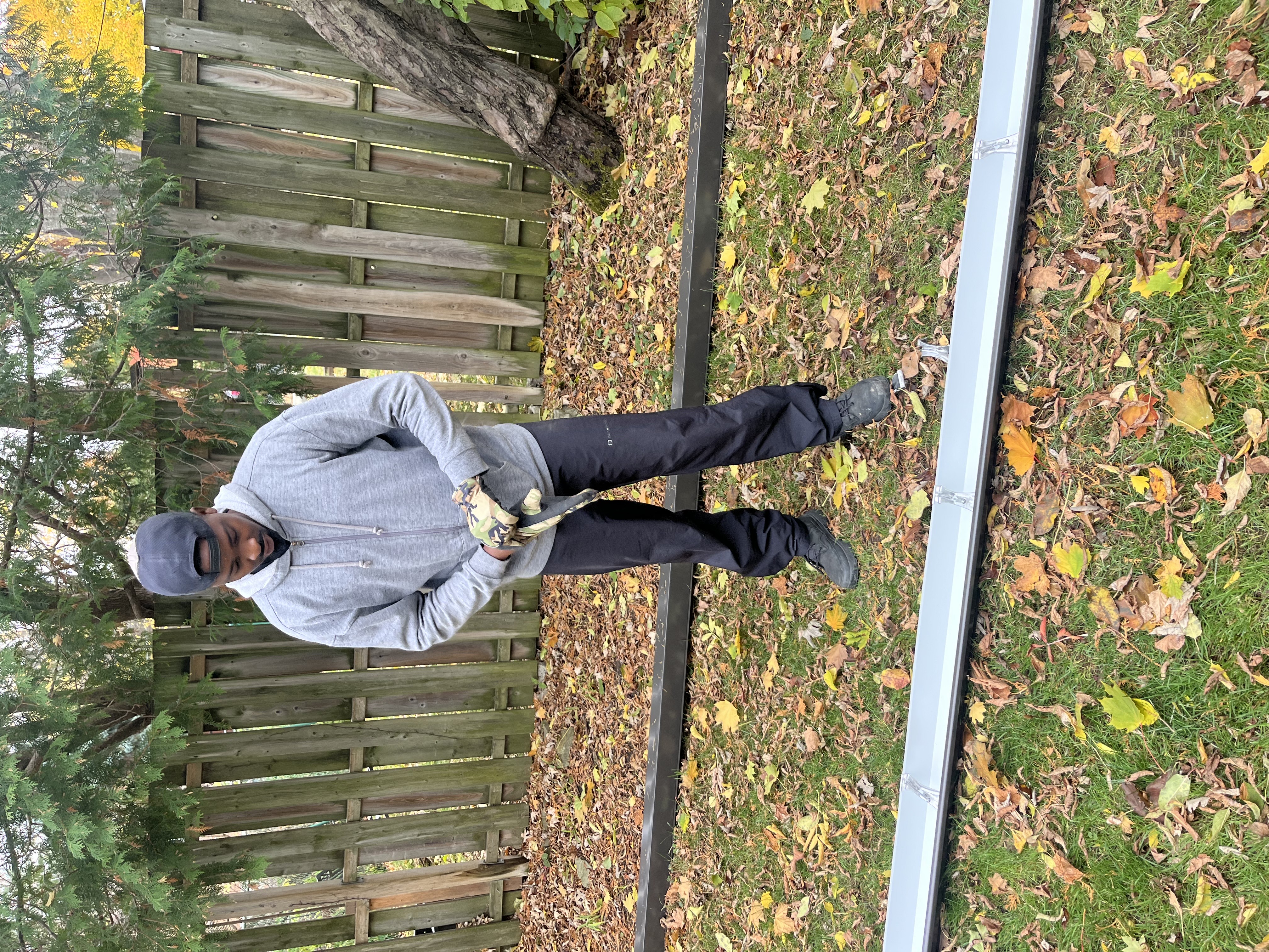 HomeShowers team member standing by completed eavestrough on ground