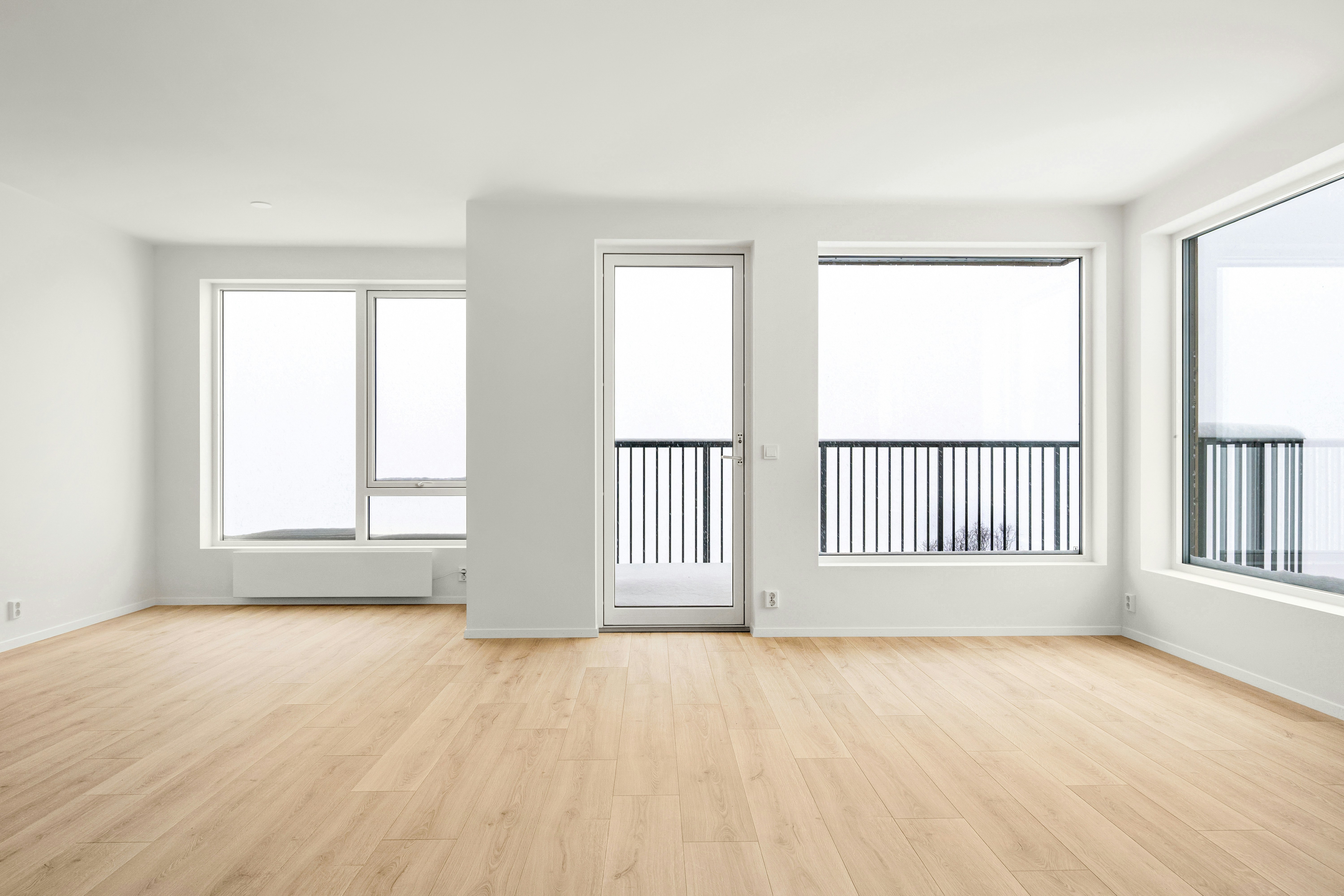 Clean empty apartment with large windows ready for move-in